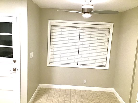 Kitchen, looking at breakfast nook area and back door.
