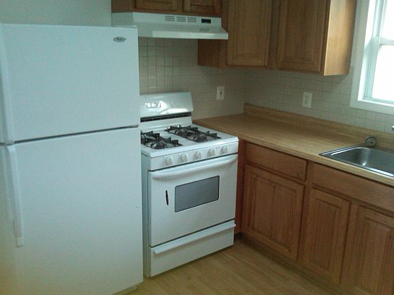 Kitchen with fridge, stove, range and dishwasher, real wood