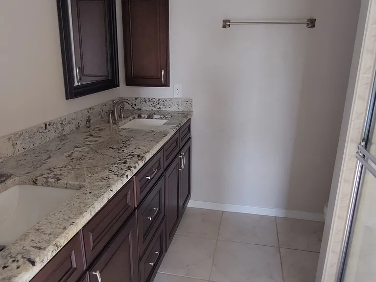 Master bathroom. 2 sinks vanity with walk-in shower and toilet