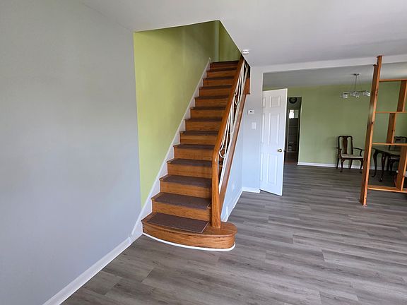 The living room has big windows (not on this picture) and is connected to the dining room. The walls are freshly painted, and new flooring was just installed