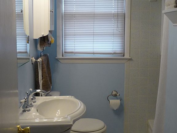 Kohler sink, original tile and cast iron tub preserved in shower