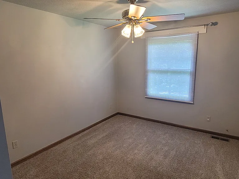 The second bedroom is a 10' x 14' space and offers pre-installed blinds and curtain rods to suit your style.