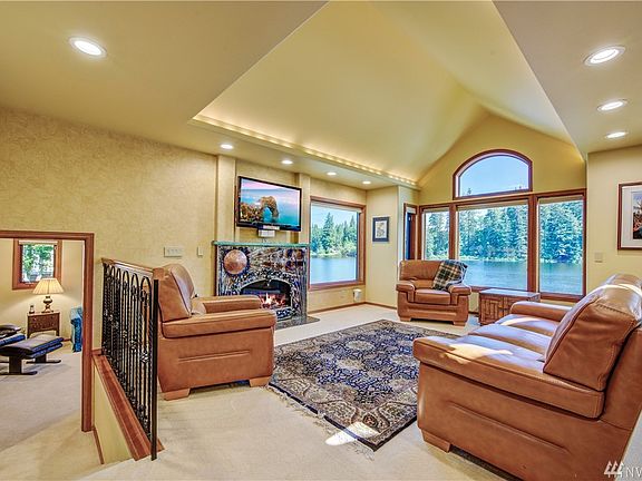 The living room has a warm fireplace with an incredible design style created by a blacksmith artist and mantle created by a glass artist.