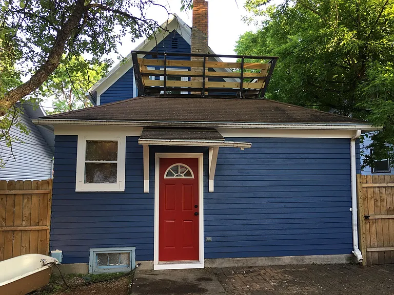 View of the back of the house from the backyard. Shows crow's nest on second floor.