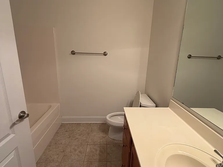 secondary full bathroom off the entry hallway and secondary bedroom