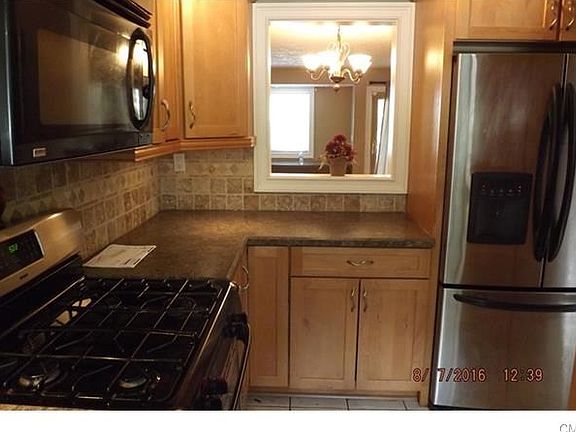 Beautiful updated Kitchen w/stainless steel appliances and gas range. View into the Living/Dining Ro