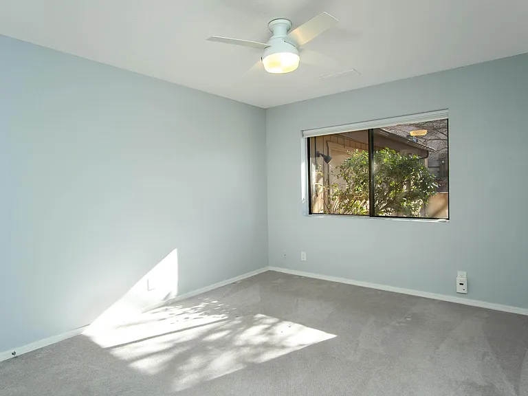 2nd bedroom. Walls are actually blueish-gray. Comfortably holds queen bed, 2 nightstands and dresser. Remote control operated blinds. Walk in closet.