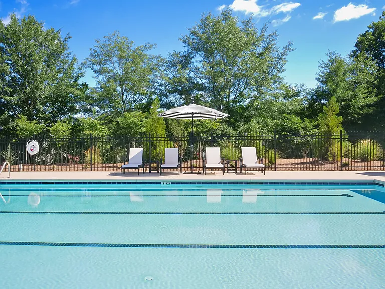 Covered poolside lounge with elegant seating.