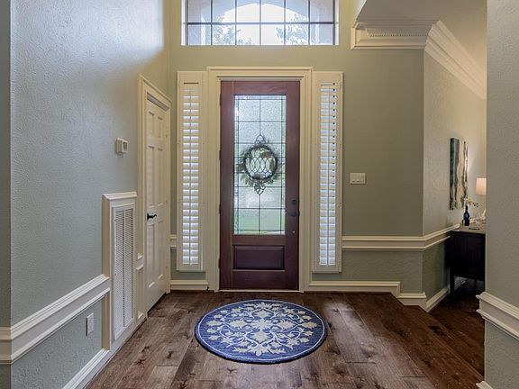 Inside the foyer you can see the beautiful new wood floors and custom shutters.