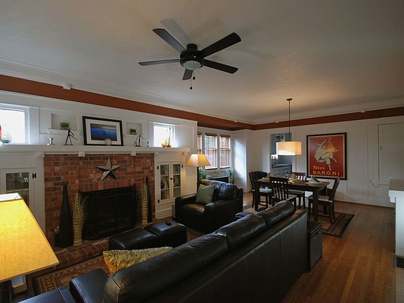 Cozy fireplace and built in casework with original leaded glass