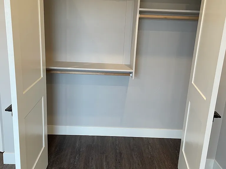Closet is an efficient mix of hang bars and shelving
