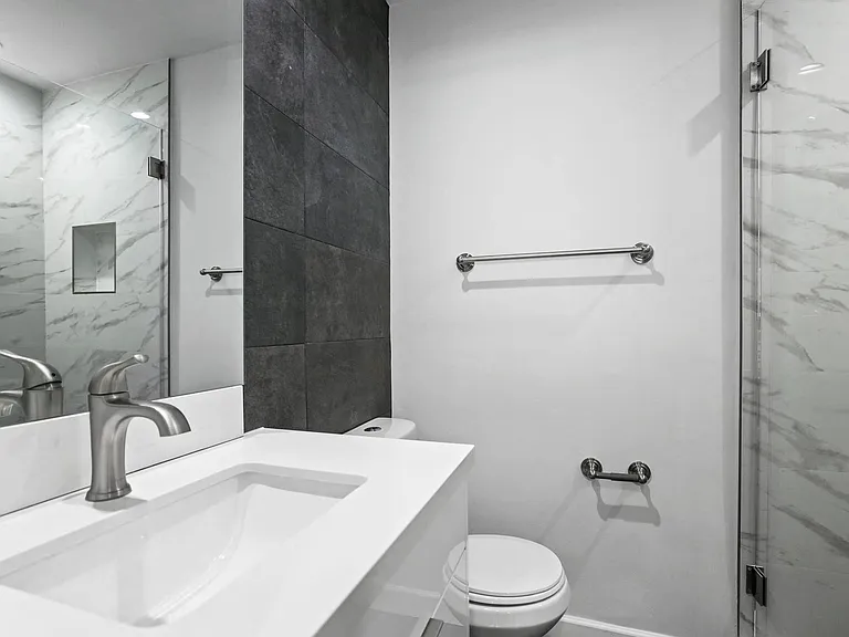Bathroom with a Stand-Up Shower and Vanity Cabinet Storage
