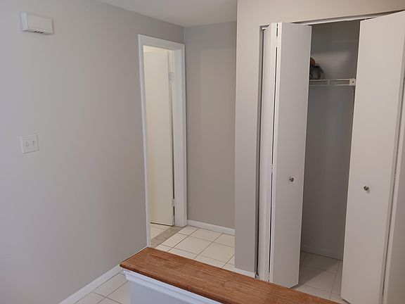 Coat Closet at Entrance & door to half bath
