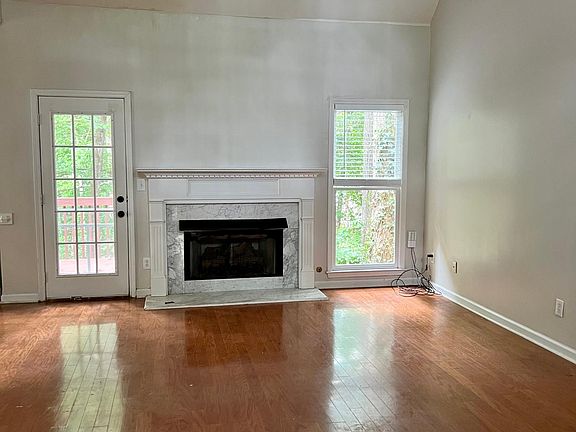 Living room with fireplace, vaulted ceilings and access to large back deck