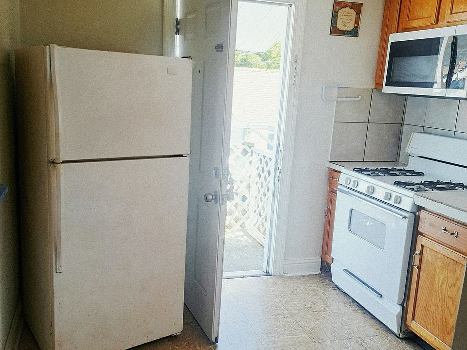 Front door, kitchen, stove, refrigerator, and microwave. Pantry and cabinets!