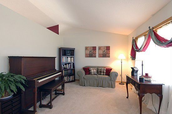 Living room welcomes your guests, with a picture window and vault ceiling