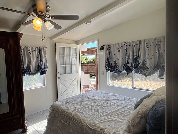 Bedroom with door open to outside patio
