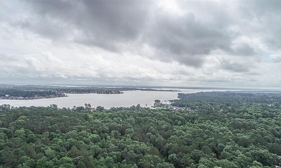 Image 1: WOW! This is the view from right above your new home! You are SO CLOSE to Lake Conroe!!! Be on it in minutes from the community boat ramp.