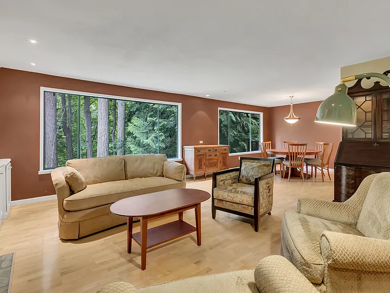 Formal living and dining room open. Big windows enjoy verdant views. Fresh neutral paint will be applied.