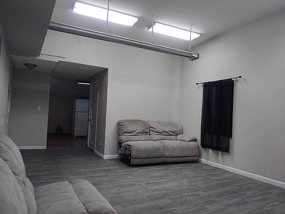 Living room with entrance to kitchen