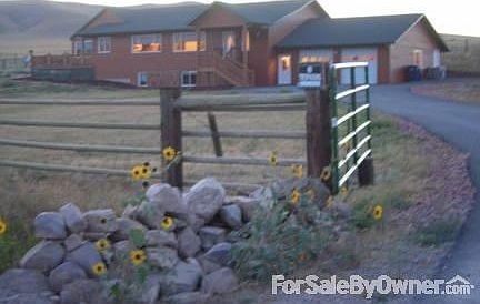 Home Seen From South
						:
						Cross fence gate to back 20 acres seen above home roof.