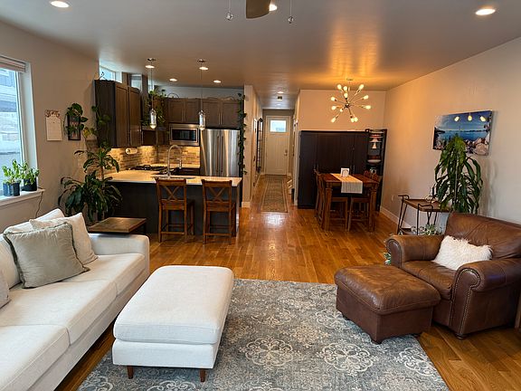 View of entry hall, kitchen, dining area, and living room