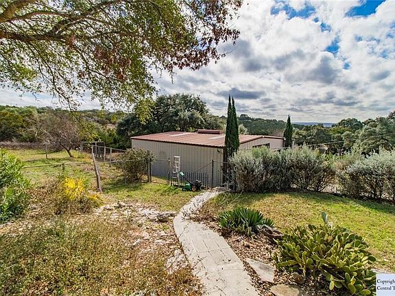 TERRACED PAVED WALKWAY TO RV & BOAT STORAGE. FENCED GARDEN TO THE LEFT
