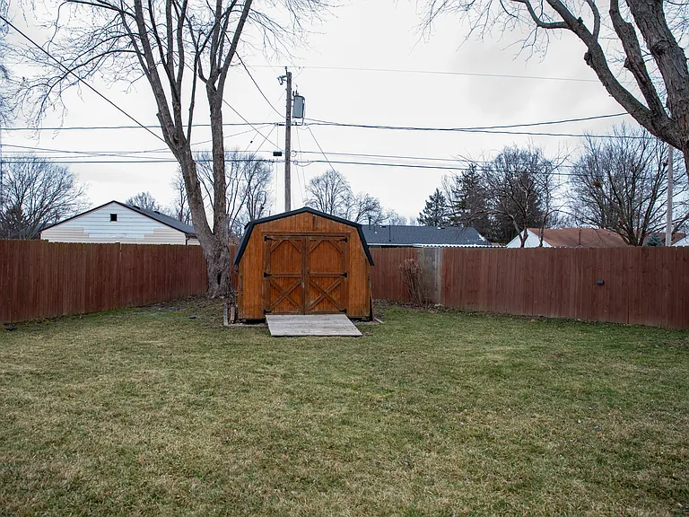 Your private backyard oasis, featuring a hot tub, stone patio, and plenty of space to relax.