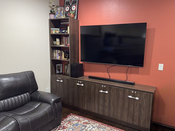 the media center and accent wall of the living room