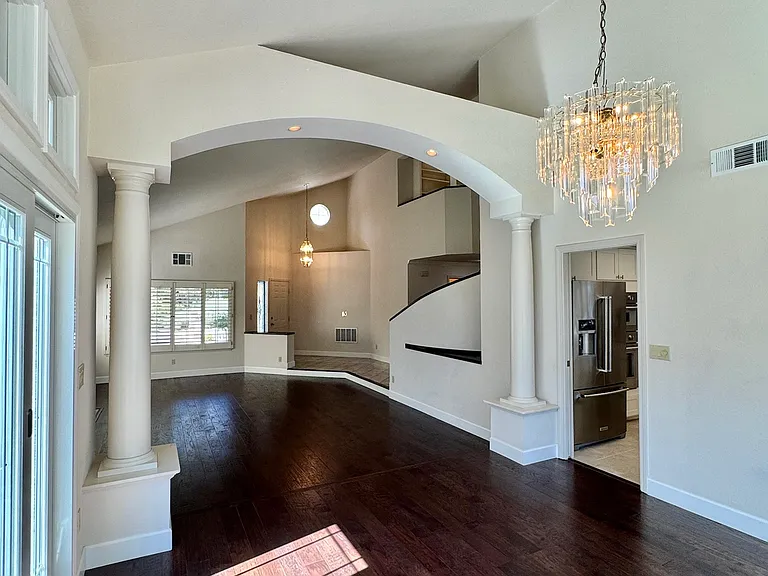 Open-concept dining room overlooking the living room