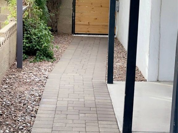 Walkway on East side of driveway leading to the backyard gate