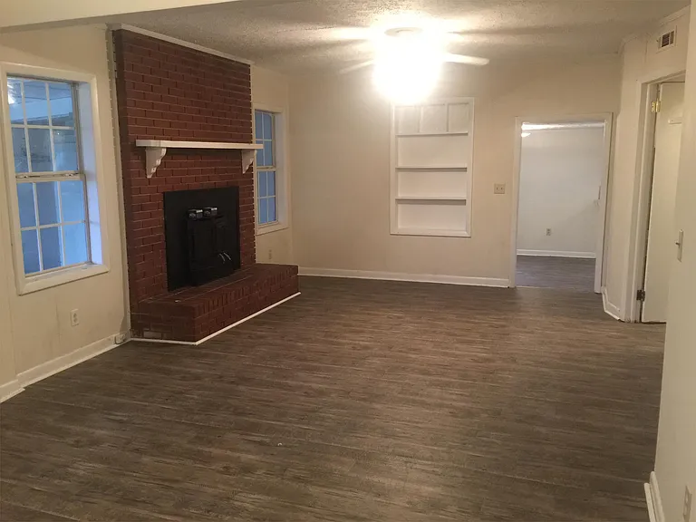 Living room with fireplace. New vinyl flooring