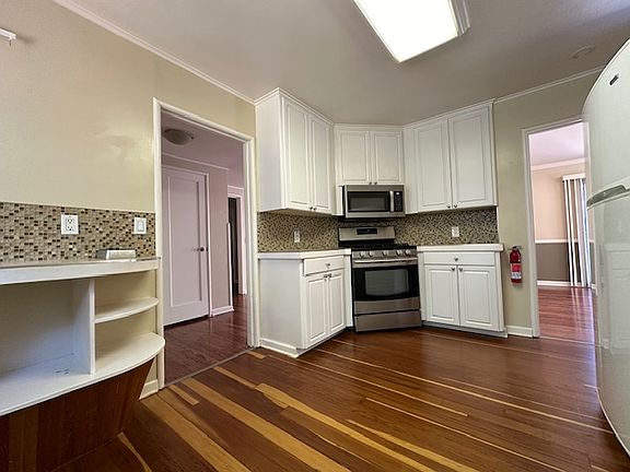 Gas stove nestled between easy use cabinets