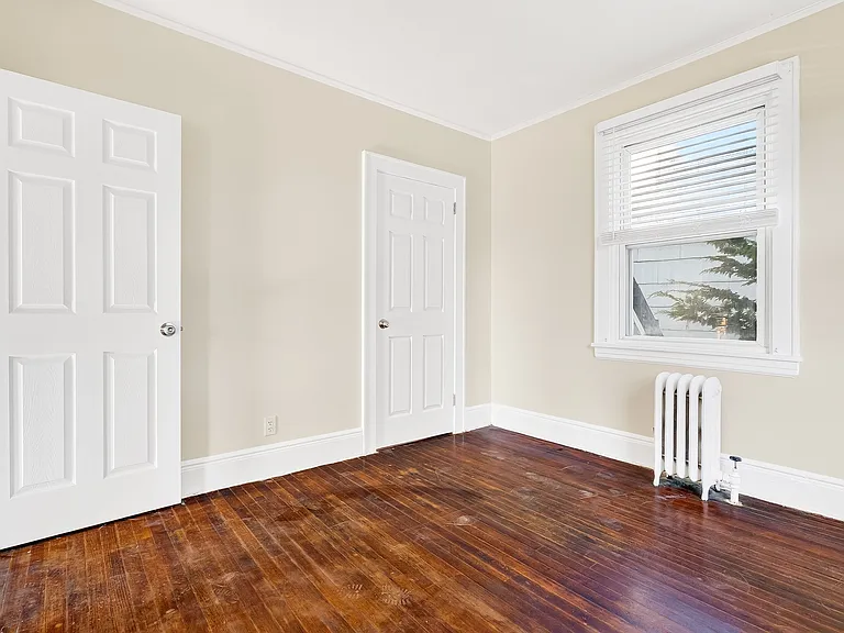 Bedroom with hardwood floors.