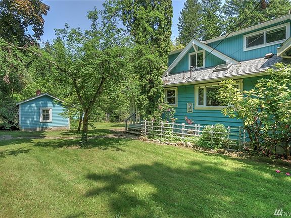 Rear porch entrance to the mudroom/laundry.  Detached shop building, 2 car garage is behind the shop.