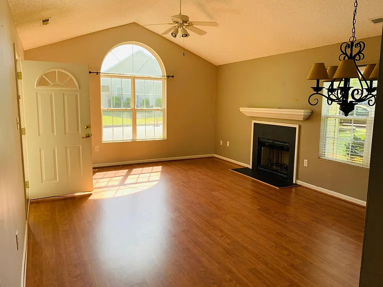 Living area/open concept floor plan with living area/ dining areas connected.