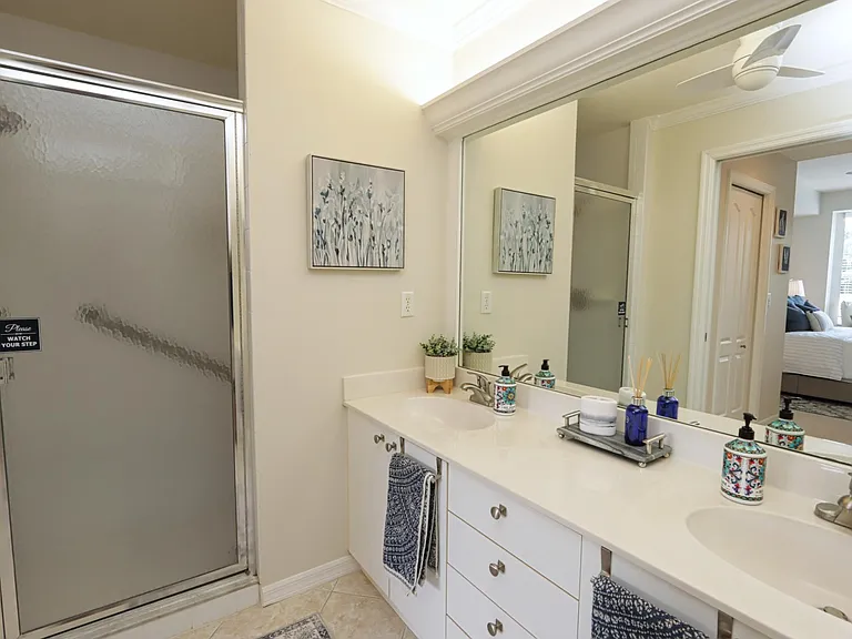 Master Bathroom w/two-sink vanity and walk-in shower w/bar and teak shower stool