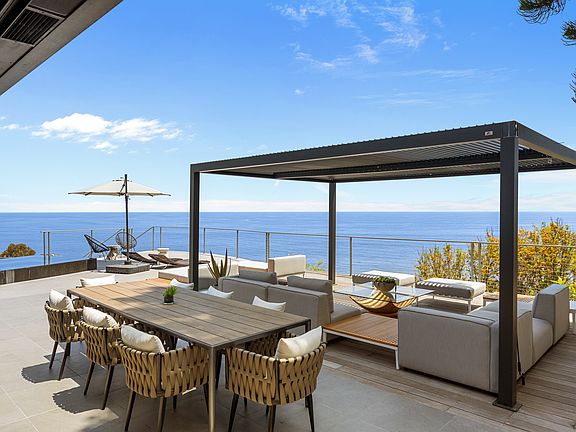 Experience the beauty of coastal living while dining outdoors, with comfortable seating and a picturesque backdrop.