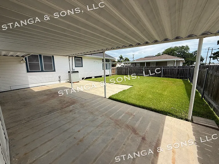 Rear carport and backyard