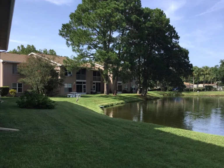 STEP OUT OF THE LANAI AND ONTO THE BEAUTIFULLY MANICURED LAWN OUTSIDE THE UNIT.