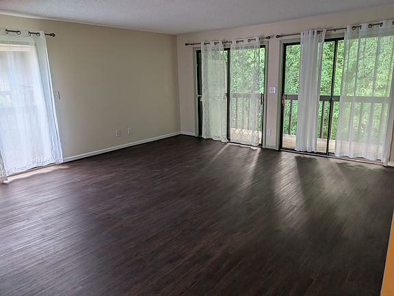 Living room with private back and side balconies.