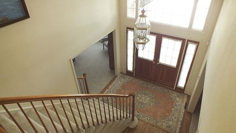 Vaulted entry with hardwoods
