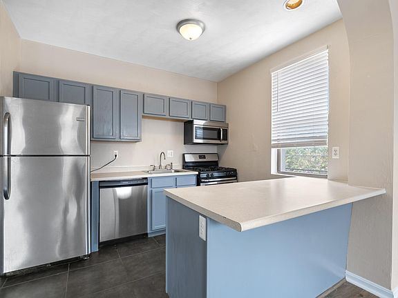 Kitchen with stainless steel appliances and an island