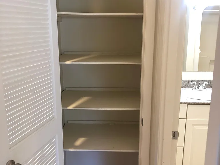 LINEN CLOSET SERVICING GUEST BATH