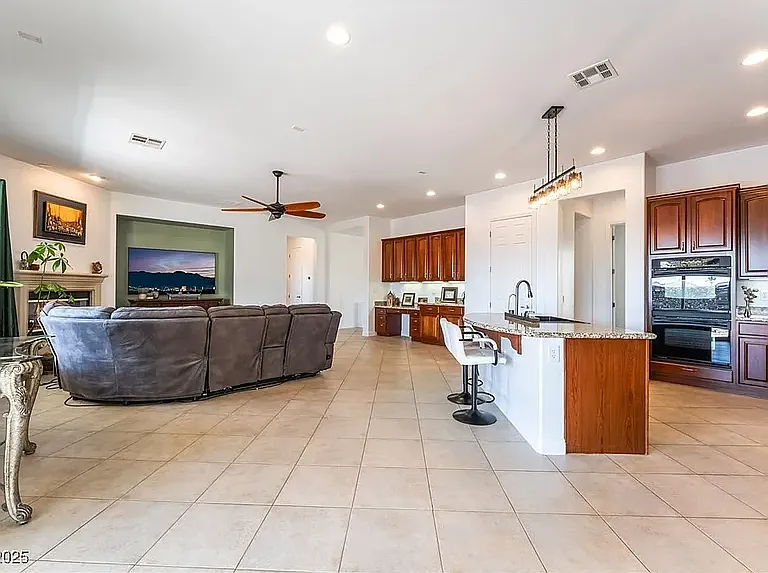 Living room connected to the kitchen for a big open space feel. Large flat screen tv.