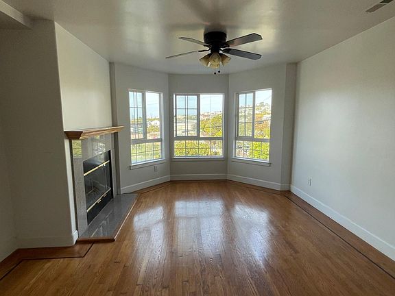 Living Area with 3 large windows facing the school