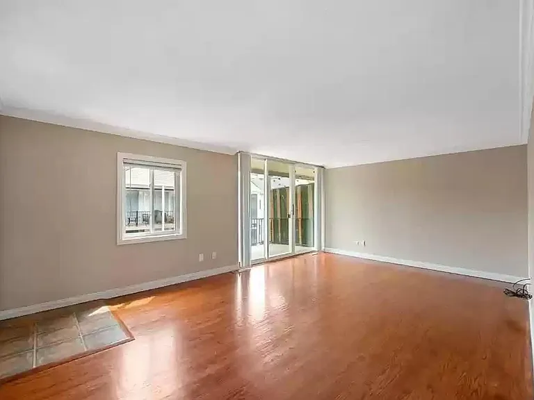 Large living room, freshly repainted, hardwood floor throughout