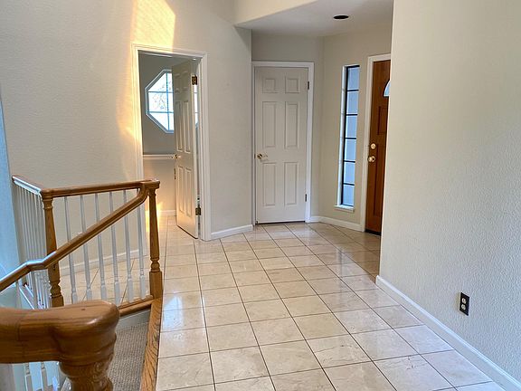 Foyer with entry closet and access to half-bathroom