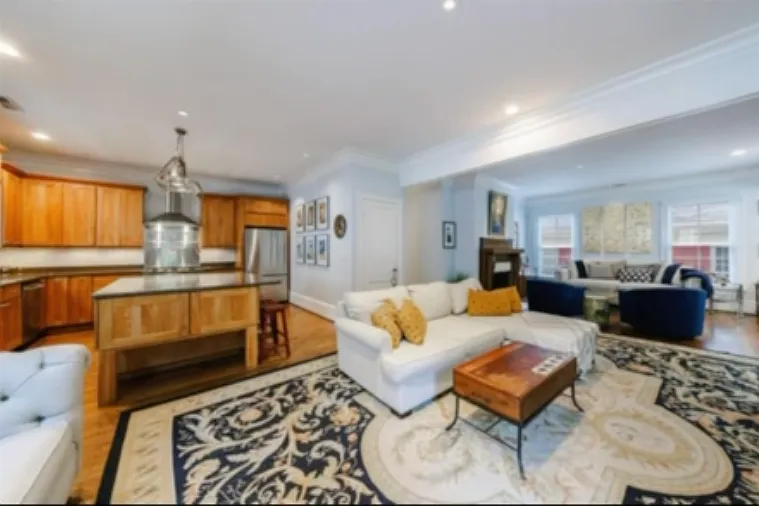 View from living room - open floor plan leads into kitchen. Note additional living space to the right with large windows. Also, dining room space adjacent to large front windows (not shown)