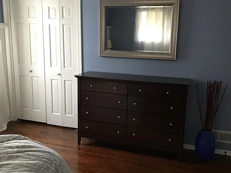 View of dresser and closet doors in master bedroom